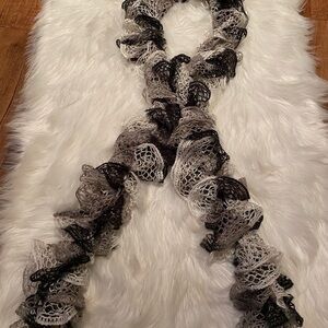 Black, grey, silver and white hand crocheted scarf.